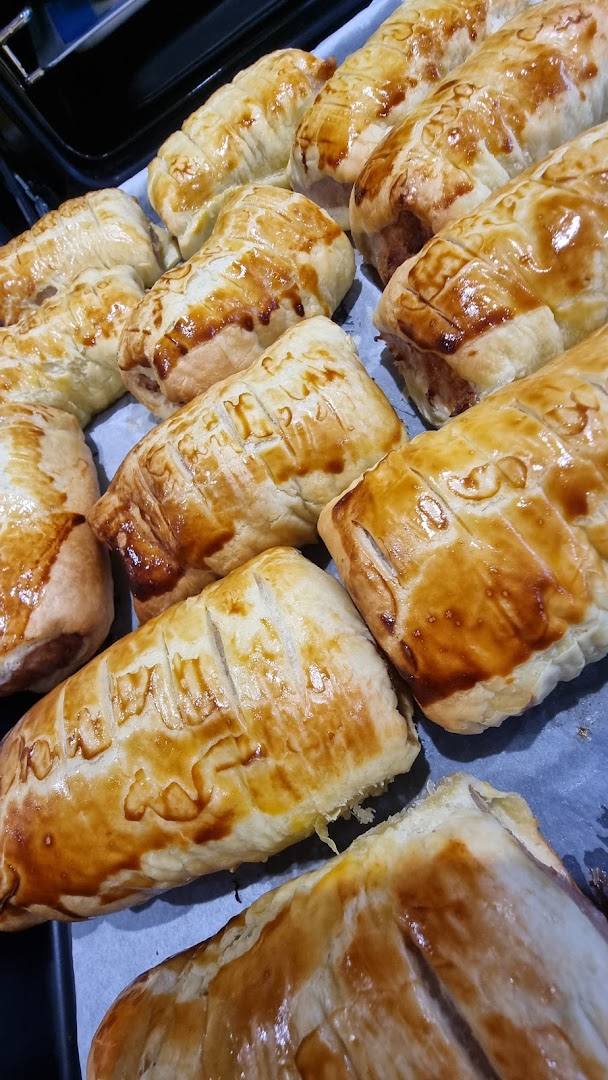 Freshly baked golden pastries on parchment paper