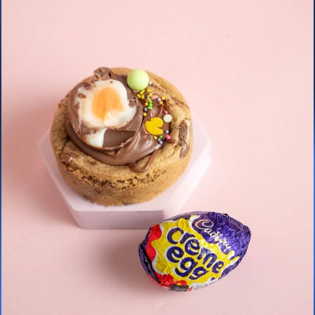 Gourmet stuffed cookie topped with a Cadbury Creme Egg and chocolate spread